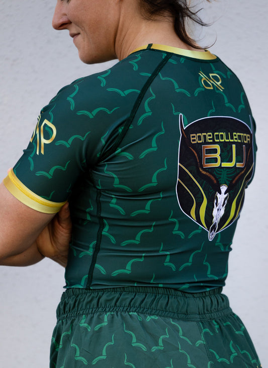 PREORDER: Women's "Bone Collector" Rash Guard 🛑 Presale Closed. Thank you for your support! Gear is in production and ships in July. 👀 Restock coming later this year – follow us on Instagram @BoneCollector_BJJ to be the first to know.